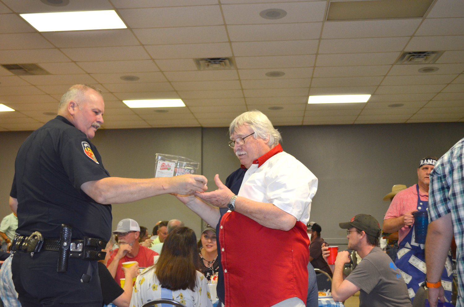 Above, Quitman Police Chief John Farmer draws the name of a lucky winner from Sam Scroggins with the child welfare board.